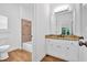 Well-lit bathroom with granite vanity, white cabinets, and a tiled shower-tub combo at 511 Millwood Ct, Canton, GA 30114