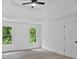 Bright bedroom features neutral carpet, trey ceiling, and two windows with natural light at 511 Millwood Ct, Canton, GA 30114