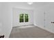 Simple bedroom with window view of lush greenery at 511 Millwood Ct, Canton, GA 30114