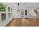 Hardwood floors, large windows with shutters, modern lighting, and access to living areas and stairs at 511 Millwood Ct, Canton, GA 30114