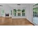 Bright dining area with large windows, hardwood floors, modern lighting, and access to a patio at 511 Millwood Ct, Canton, GA 30114