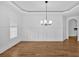 Spacious dining room with wainscoting, hardwood floors and modern light fixture at 511 Millwood Ct, Canton, GA 30114