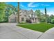 Side view of a two-story house with a long driveway and a two-car garage at 511 Millwood Ct, Canton, GA 30114