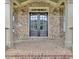 Close-up of a double front door with glass panels and brick surround at 511 Millwood Ct, Canton, GA 30114