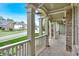 Covered front porch with brick flooring and white columns at 511 Millwood Ct, Canton, GA 30114