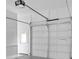 Clean and bright two car garage with white walls and ceiling. Includes the garage door and door to the house at 511 Millwood Ct, Canton, GA 30114