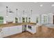 Spacious kitchen with white cabinets, granite countertops, stainless steel appliances, and a view of living spaces at 511 Millwood Ct, Canton, GA 30114