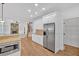 Well-lit kitchen with white cabinets, granite counters, stainless steel appliances, and walk-in pantry at 511 Millwood Ct, Canton, GA 30114