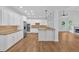 Bright kitchen with granite countertops, hardwood floors, and white cabinetry at 511 Millwood Ct, Canton, GA 30114