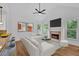 Open living space with hardwood floors, fireplace, modern lighting, and bar seating at 511 Millwood Ct, Canton, GA 30114