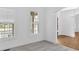 Bright living room with windows featuring shutters, hardwood floors and a decorative archway at 511 Millwood Ct, Canton, GA 30114