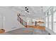 Bright living room showcasing a staircase, large windows, and open kitchen at 511 Millwood Ct, Canton, GA 30114