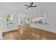 Open concept living area with hardwood floors, modern lighting, a kitchen bar, and fireplace at 511 Millwood Ct, Canton, GA 30114