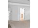 This spacious room has neutral carpeting, a door leading outside, and updated lighting at 511 Millwood Ct, Canton, GA 30114