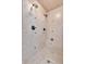 This remodeled shower features dual shower heads, tan tile, and a built-in seat at 511 Millwood Ct, Canton, GA 30114