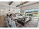 Open-concept living room with modern furnishings and access to outdoor patio at 5305 Memento Trace, Cumming, GA 30040