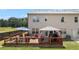 Rear exterior of home with outdoor deck and patio furniture and grassy backyard at 2700 Norwich Trce, Snellville, GA 30078