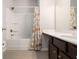 Bathroom features a floral curtain with a tub and shower combo and single sink at 2700 Norwich Trce, Snellville, GA 30078