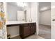 Bathroom with a modern sink, dark wooden cabinets, and an open doorway to another room at 2700 Norwich Trce, Snellville, GA 30078