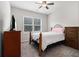 Bedroom featuring a window, carpet, ceiling fan, dresser and iron frame bed at 2700 Norwich Trce, Snellville, GA 30078