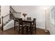 Cozy dining area with dark wood furniture and staircase at 2700 Norwich Trce, Snellville, GA 30078