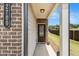 Exterior entrance featuring brick, siding, and well-lit porch at 2700 Norwich Trce, Snellville, GA 30078