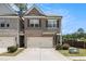 Charming two-story townhome with brick accents, attached garage, and well-manicured landscaping at 2700 Norwich Trce, Snellville, GA 30078