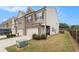 A row of townhomes with a grassy backyard and wood fence at 2700 Norwich Trce, Snellville, GA 30078