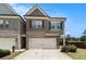 Two-story townhome with brick and siding, attached garage, and well-maintained lawn at 2700 Norwich Trce, Snellville, GA 30078