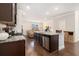 Modern kitchen with granite counters, stainless steel appliances open to the living area at 2700 Norwich Trce, Snellville, GA 30078
