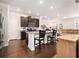 Open kitchen layout with dark wood floors, stainless steel appliances and an eat-in island at 2700 Norwich Trce, Snellville, GA 30078