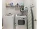 Laundry room with front loading washer and dryer and shelving at 2700 Norwich Trce, Snellville, GA 30078