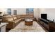 Living room with a large sofa, area rug, TV, and windows at 2700 Norwich Trce, Snellville, GA 30078