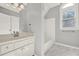 Bathroom with tub, marble floors, white vanity, arched window, and neutral colors at 4955 Day Lily Nw Way, Acworth, GA 30102