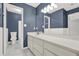 Bathroom features white cabinets, gray tiled floors and blue accent walls at 4955 Day Lily Nw Way, Acworth, GA 30102