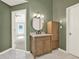 Elegant bathroom featuring a wood vanity with a large, round mirror at 4955 Day Lily Nw Way, Acworth, GA 30102