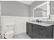 Modern bathroom with a marble vanity, illuminated mirror, and wainscoting at 4955 Day Lily Nw Way, Acworth, GA 30102