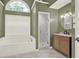 Stylish bathroom featuring a soaking tub, walk-in shower, and elegant vanity at 4955 Day Lily Nw Way, Acworth, GA 30102