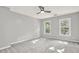Neutral bedroom featuring two sunlit windows and plush carpet flooring at 4955 Day Lily Nw Way, Acworth, GA 30102