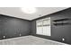 Charming bedroom features neutral carpet, accent wall, and sunlit window at 4955 Day Lily Nw Way, Acworth, GA 30102