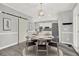 Charming dining area featuring a sliding barn door, modern lighting, and open access to the kitchen at 4955 Day Lily Nw Way, Acworth, GA 30102