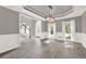 Spacious dining room with wainscoting, large windows, and a view of the staircase and entry hall at 4955 Day Lily Nw Way, Acworth, GA 30102