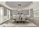 Elegant dining room with modern light fixture, wainscoting, and large windows for natural light at 4955 Day Lily Nw Way, Acworth, GA 30102