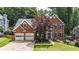 Beautiful two-story brick home featuring a two-car garage and well-manicured lawn at 4955 Day Lily Nw Way, Acworth, GA 30102