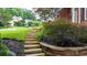 Beautifully landscaped front yard with stone steps leading to a brick home at 4955 Day Lily Nw Way, Acworth, GA 30102