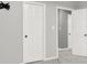 Hallway with gray walls, white trim and doors, and concrete floors at 4955 Day Lily Nw Way, Acworth, GA 30102