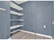 Bright laundry room with blue walls and open shelving for storage solutions at 4955 Day Lily Nw Way, Acworth, GA 30102