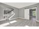 Spacious living room with a sliding barn door and hardwood floors, providing an inviting space at 4955 Day Lily Nw Way, Acworth, GA 30102