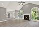 Bright and open living room with a fireplace, vaulted ceiling, and large arched windows at 4955 Day Lily Nw Way, Acworth, GA 30102