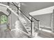 Bright foyer showcases a staircase with white railings and gray walls leading to the upper level at 4955 Day Lily Nw Way, Acworth, GA 30102